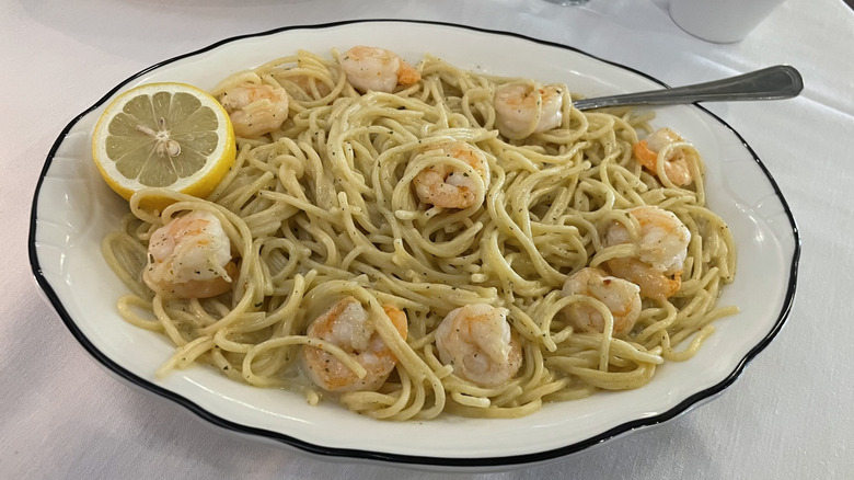 Shrimp Scampi with sliced lemon on a plate
