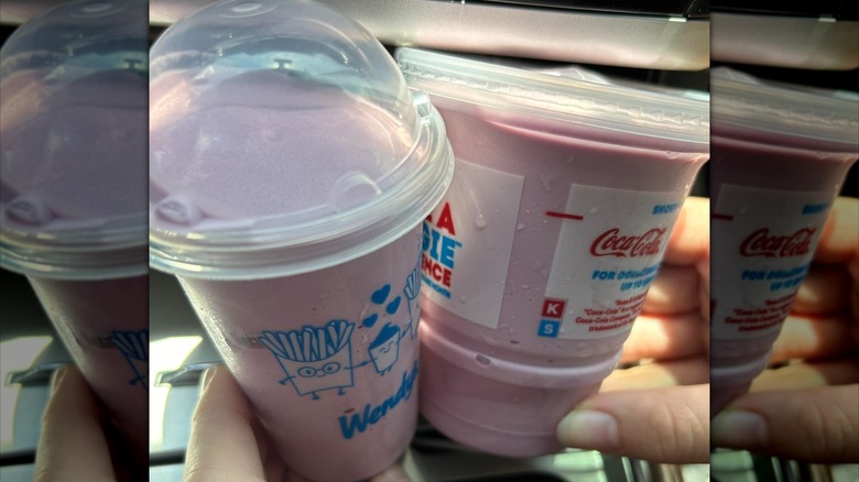 Hands holding a Triple Berry Frosty