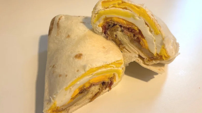 Bacon breakfast burrito sliced in half
