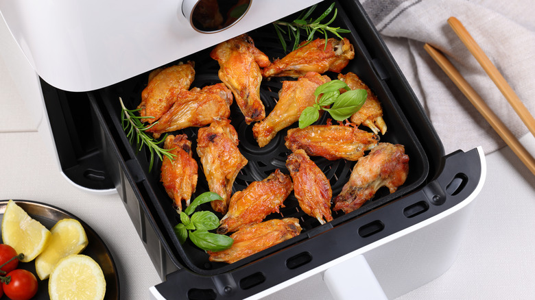 Crispy chicken wings in white air fryer