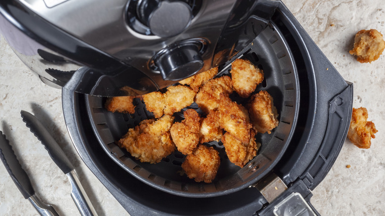 Fried chicken nuggets in air fryer basket