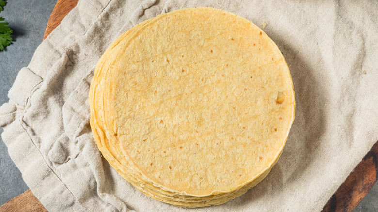 Stack of corn tortillas on grey towel