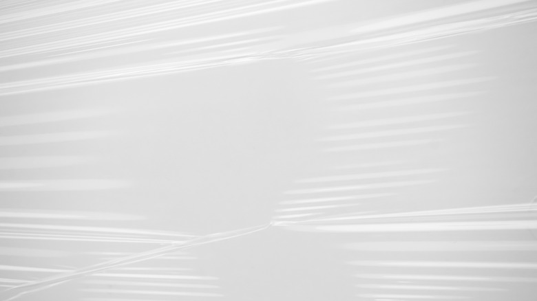 Stretched plastic wrap over white background