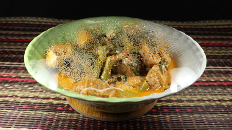 Plastic wrap over bowl of food reheated in microwave