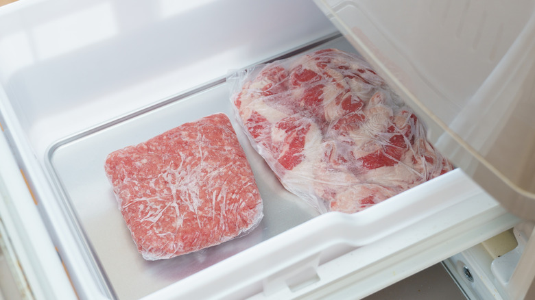 Meat wrapped in plastic in freezer