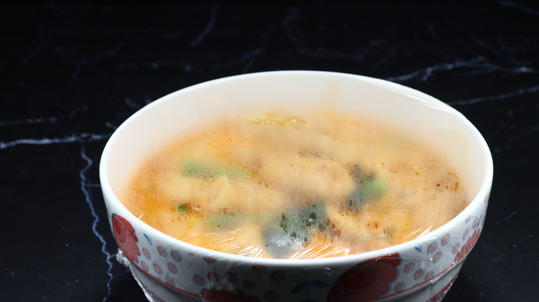 Plastic wrap with condensation over reheated dish