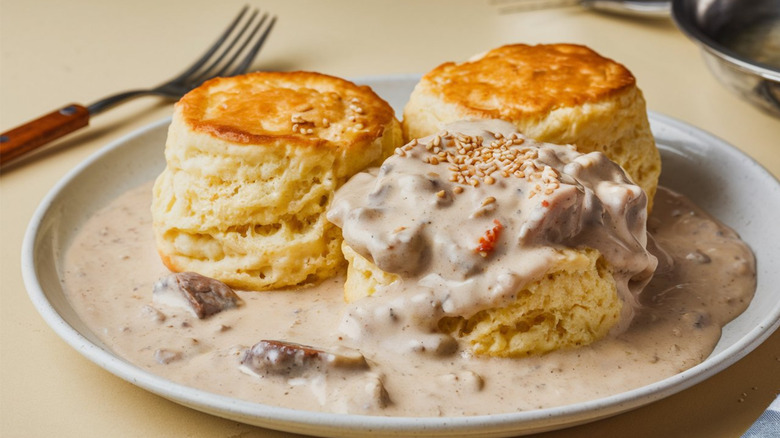 Biscuits and gravy on white plate