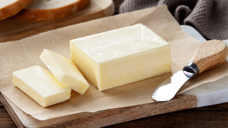 Sliced pieces of yellow butter on parchment paper