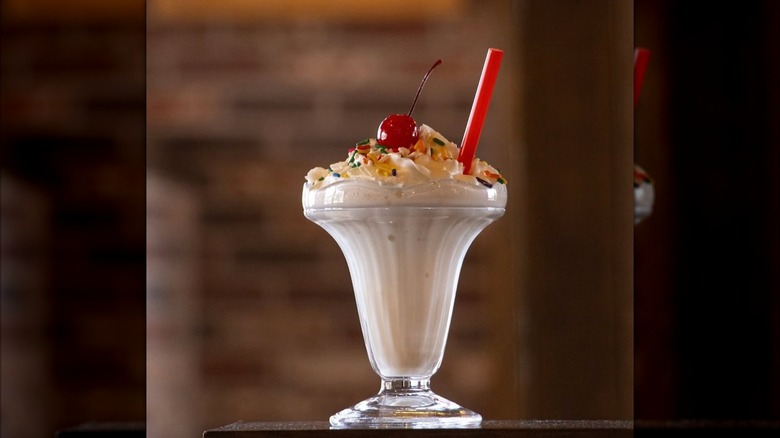 Zaxby's milkshake in glass with red straw