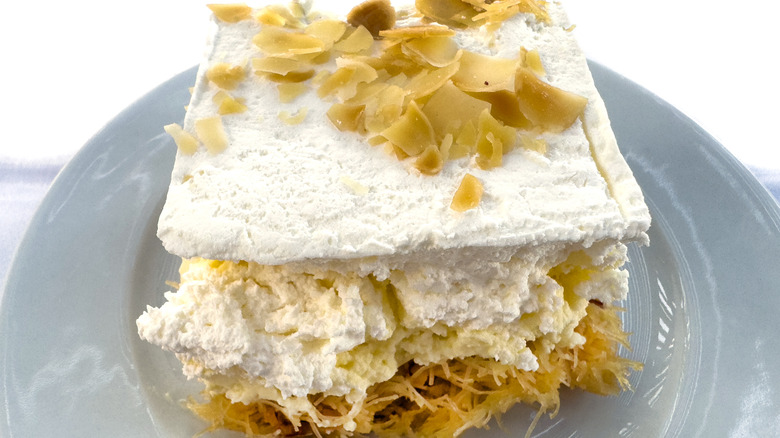 A slice of Greek ekmek kataifi on a grey plate