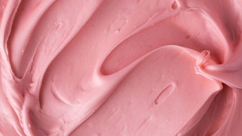 Pink cake frosting close up