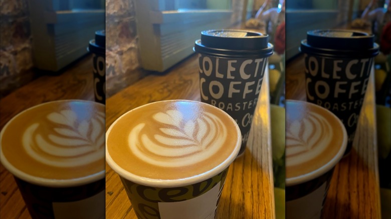 Smoked white mocha topped with latte art on wooden countertop
