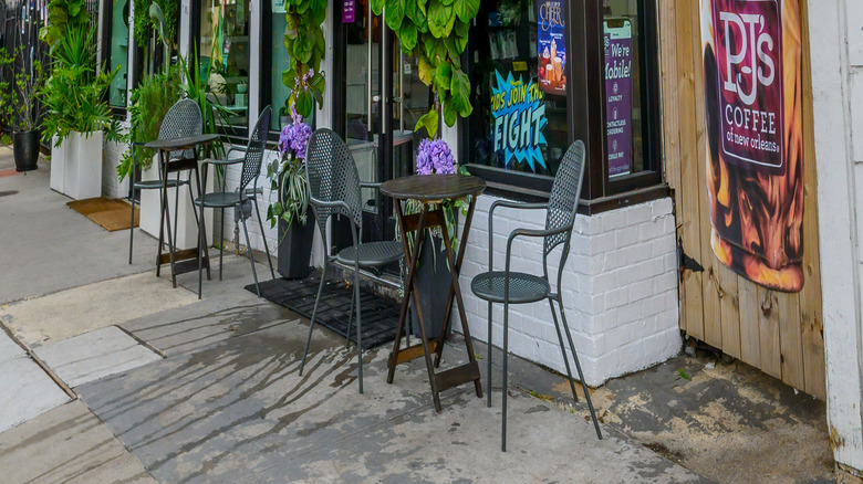 Exterior of PJ's Coffee location with chairs and tables in New Orleans, Louisiana
