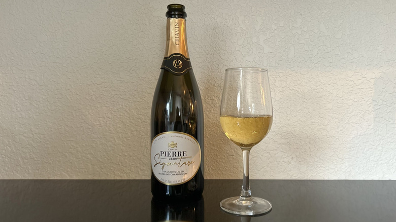 A bottle and glass of Pierre Zéro Signature Sparkling Chardonnay