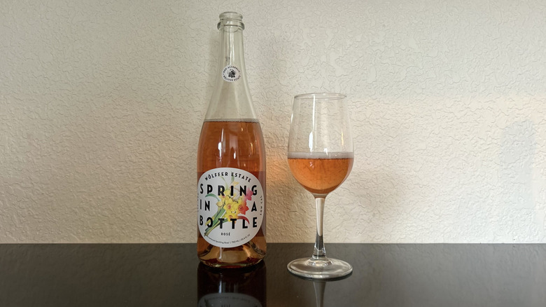 A bottle and glass of Wölffer Estates Spring in a Bottle Rosé