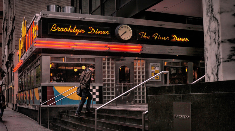 man walking into a diner in New York City