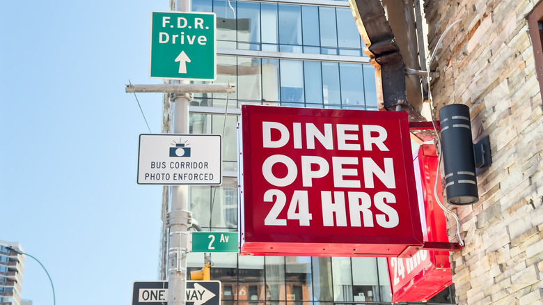 a sign in New York City advertising a 24 hour diner