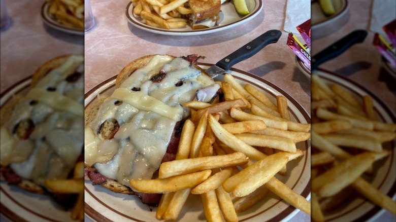 large plate of a deli sandwich and fries at a diner
