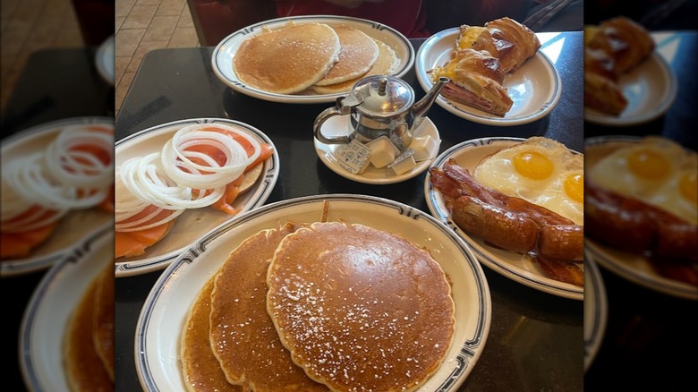 table filled with large plates of breakfast food