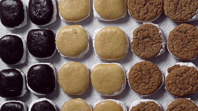 whoopie pies laid out in a straight lines on a table