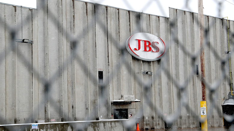 A JBS meat packing plant through a wired fence
