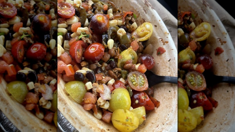 close up of Chipotle burrito bowl with lots of veg, sofritas, and beans