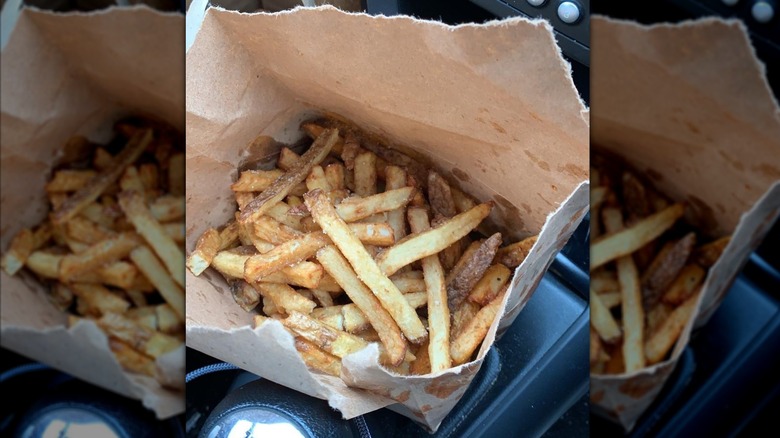 open bag of fries in car, mirrored image