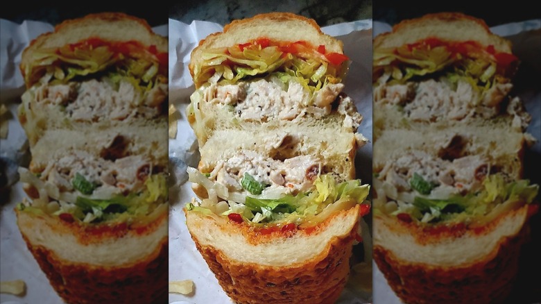 Jersey Mike's Chicken Salad Sub sandwich cut in half to show fillings