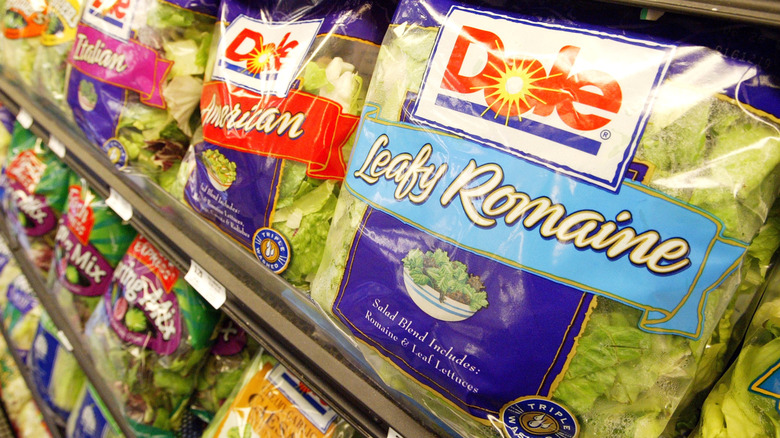pre-packaged Dole salads on shelf at store