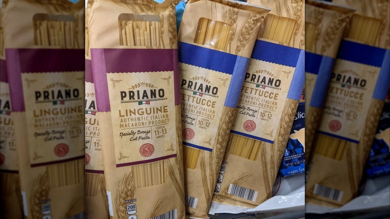 Mirrored image of three packets of Priano bronze cut pasta, one linguine and two fettuccine