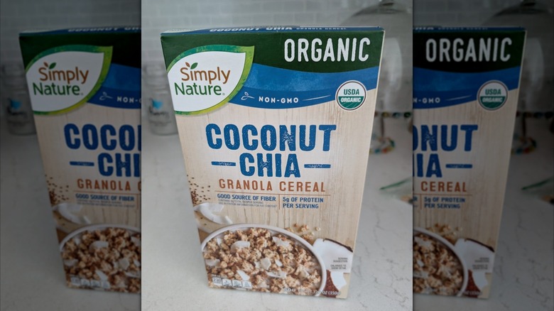 Mirrored image of Coconut chia granola cereal box on white kitchen counter