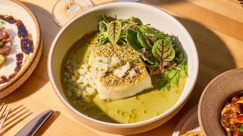 Plated sole fish topped with pistachios and onions