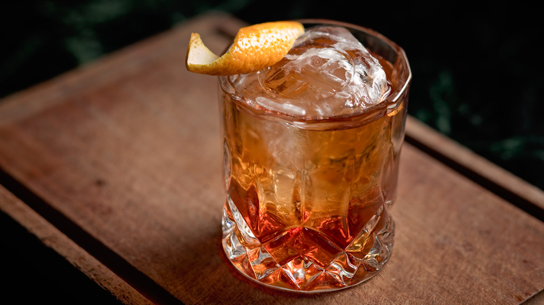 Old-Fashioned cocktail on cutting board