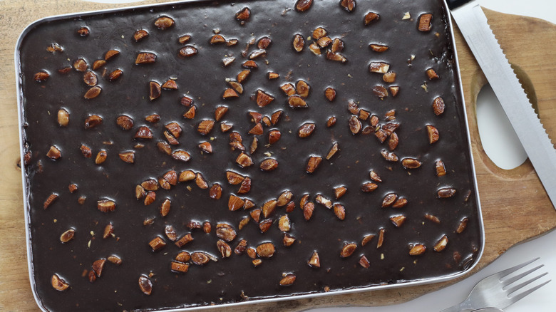 Top view of Texas sheet cake in silver pan on wooden chopping board