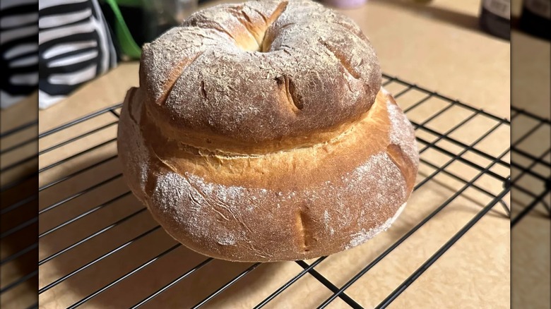 Cottage loaf on black grill on brown surface
