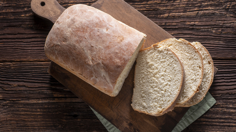 Sliced Loaf of Homemade White Bread on a wooden board