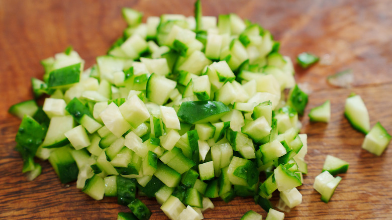 Chopped cucumber on wooden board