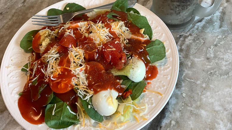 salad with eggs and bacon and tomato dressing