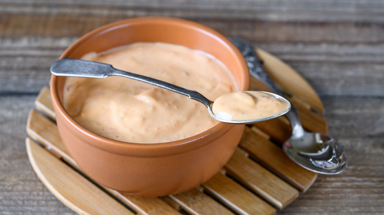 bowl and spoon of pink salad dressing