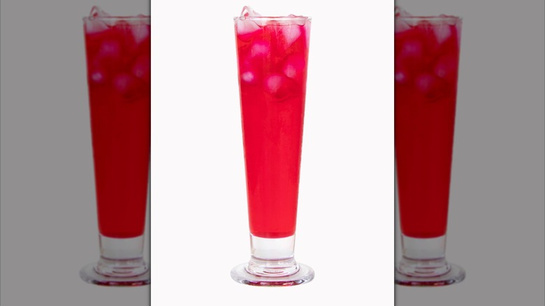 Red nectar in tall glass isolated on white background