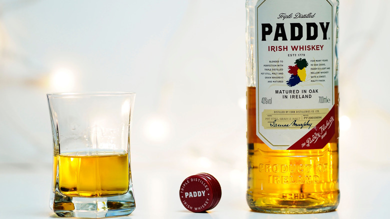A bottle and glass of Paddy's Irish Whiskey