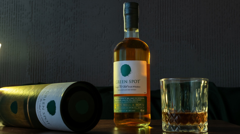 A bottle and glass of Green Spot Irish whiskey