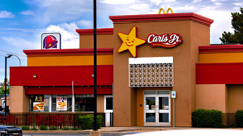 Outside a Carl's Jr. restaurant with a McDonald's and Taco Bell sign in the background
