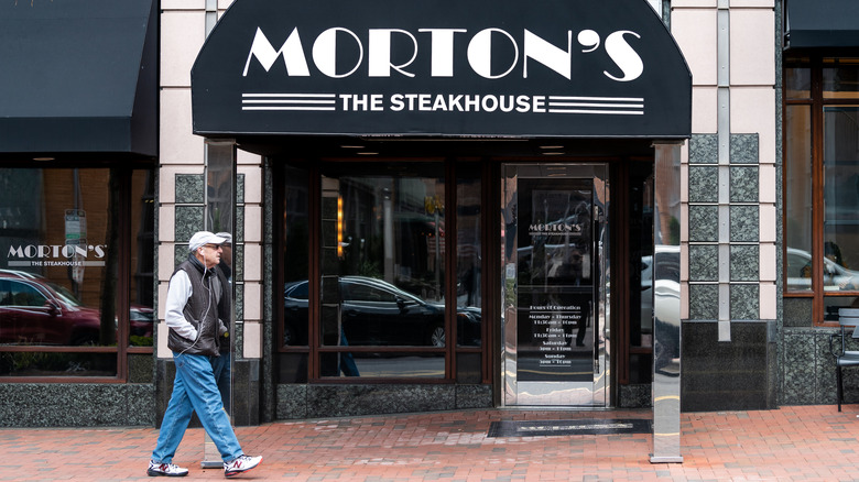 Front of a Morton's Steakhouse as a man walks by