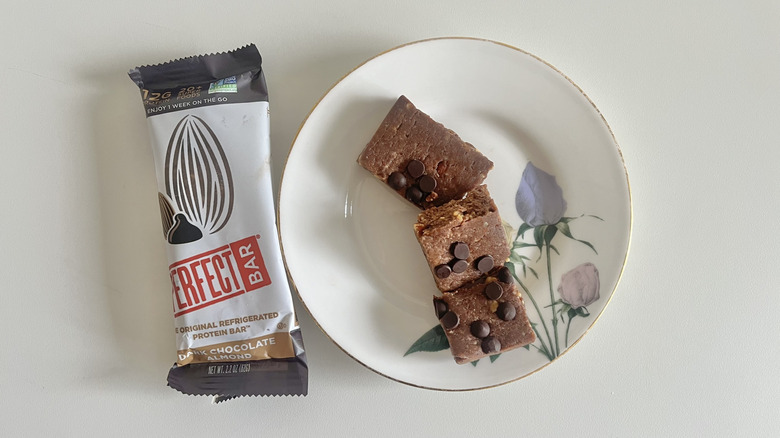 Dark Chocolate Almond Perfect Bar on a plate next to the wrapper