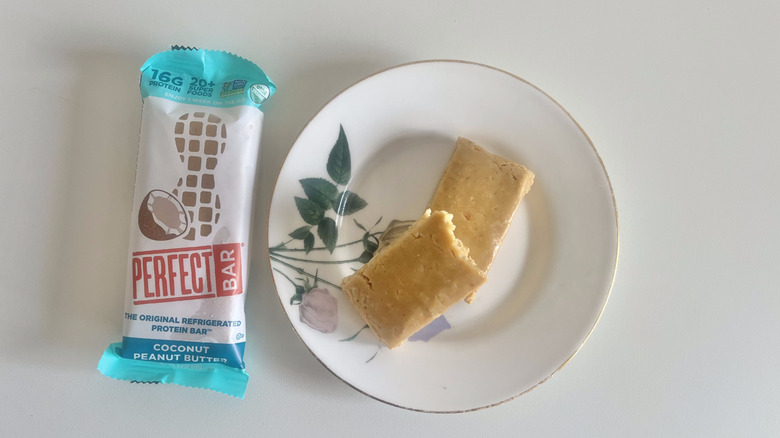 Coconut Peanut Butter Perfect Bar on a plate next to the wrapper