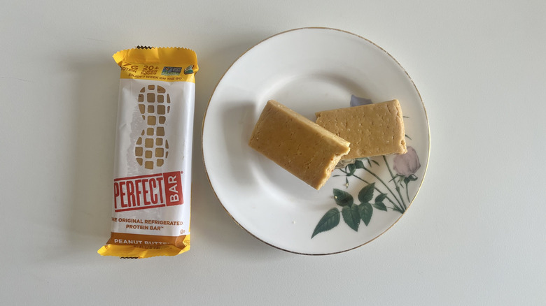 Peanut Butter Perfect Bar on a plate next to the wrapper