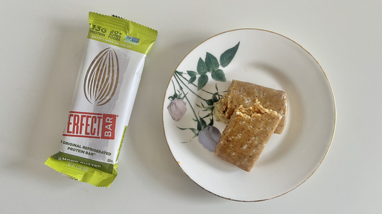 Almond Butter Perfect Bar on a plate next to the wrapper