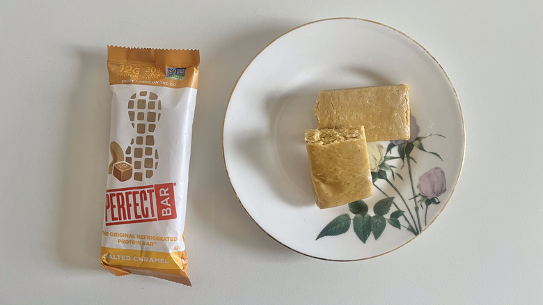 Salted Caramel Perfect Bar on a plate next to the wrapper