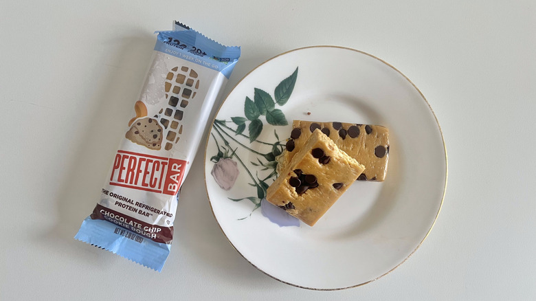 Chocolate Chip Cookie Dough Perfect Bar on a plate next to the wrapper